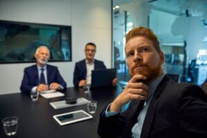 Portrait of businessman turning round in a meeting